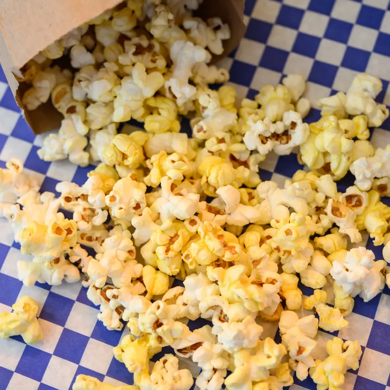 Fresh buttered popcorn spilling out of a bag