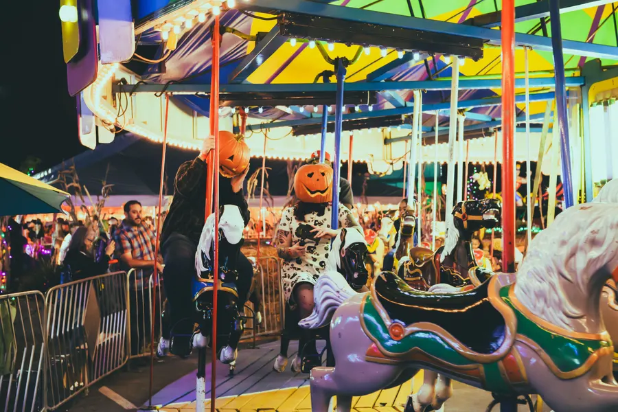 Pumpkin-headed riders on the carousel