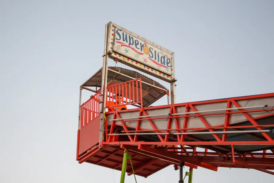 The Super Slide sign against the evening sky