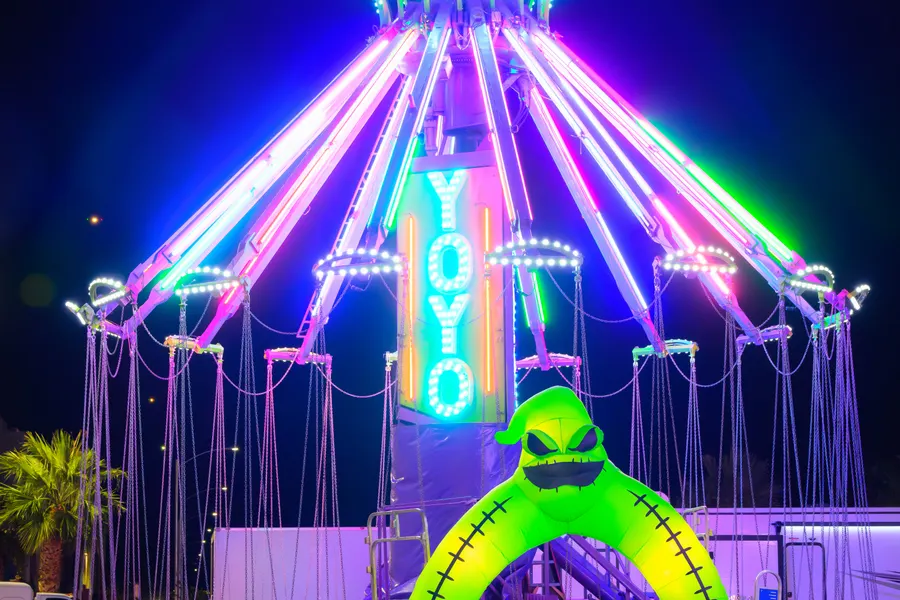 The YoYo swing ride in neon at night