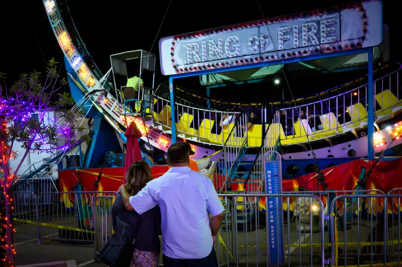 A couple sitting together watching the Ring of Fire loop at night